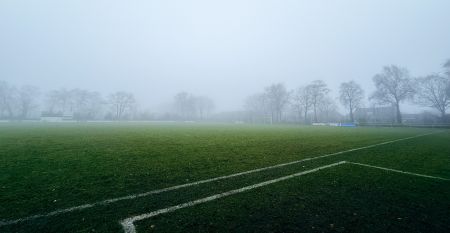 Das Sporthotel Bruurs ist ein modernes zweist&ouml;ckiges Geb&auml;ude mit gelben D&auml;chern und Wellness-Schildern, umgeben von gr&uuml;nen Hecken und B&auml;umen in Baarle-Nassau unter einem teilweise bew&ouml;lkten Himmel - ideal f&uuml;r ein Trainingslager.