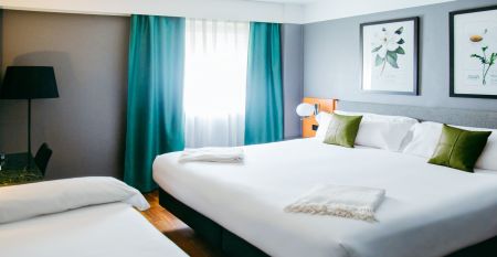 Das moderne, hellgraue Hotel Malcom & Barret Valencia*** besticht durch ein gro&szlig;es HOTEL-Schild, vor dem Motorroller und ein Auto geparkt sind &ndash; ein einladender Ort f&uuml;r die Fu&szlig;ballmannschaften aus Valencia w&auml;hrend ihres Trainingslagers.